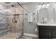 Contemporary bathroom features a glass enclosed shower with tile surround and vanity with a black cabinet at 3173 Long Avenue Ext., Conway, SC 29526