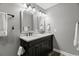 Bathroom features double sinks with black cabinets and a large framed mirror at 3173 Long Avenue Ext., Conway, SC 29526