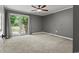 Bedroom with neutral carpet and ceiling fan with a sliding glass door at 3173 Long Avenue Ext., Conway, SC 29526