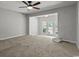 Bedroom with neutral carpet and ceiling fan, with access to outdoor living space at 3173 Long Avenue Ext., Conway, SC 29526