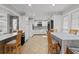 Bright kitchen and dining area featuring white cabinets, modern appliances, and tiled floors at 3173 Long Avenue Ext., Conway, SC 29526