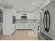 Modern kitchen featuring white cabinets, stainless steel appliances, and tile flooring at 3173 Long Avenue Ext., Conway, SC 29526