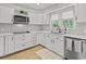 Well-lit kitchen with white cabinets, stainless steel appliances, and stylish backsplash at 3173 Long Avenue Ext., Conway, SC 29526
