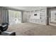 Bright living room featuring custom built-ins, wood paneling, and large windows for plenty of natural light at 3173 Long Avenue Ext., Conway, SC 29526