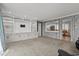 Open living room with a built-in entertainment center, seamless flow to the kitchen, and neutral tones at 3173 Long Avenue Ext., Conway, SC 29526