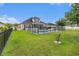 Spacious backyard features a fenced-in pool, manicured lawn, and outdoor living area at 325 Galway Ct., Longs, SC 29568