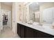 Bathroom with double vanity, framed mirror, and open doorway leading to a walk-in closet at 325 Galway Ct., Longs, SC 29568