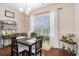 Cozy dining area featuring a dark wood table, seating for four, and natural light from the window with sheer curtains at 325 Galway Ct., Longs, SC 29568