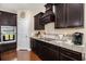 Well-equipped kitchen featuring dark cabinetry, granite countertops, and modern appliances for culinary enthusiasts at 325 Galway Ct., Longs, SC 29568