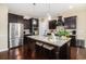 Beautiful kitchen boasts dark cabinetry, granite countertops, stainless steel appliances, and an island with seating at 325 Galway Ct., Longs, SC 29568