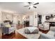 Spacious open-concept living area featuring hardwood floors, a ceiling fan, and seamless flow into dining and kitchen at 325 Galway Ct., Longs, SC 29568