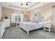 Serene main bedroom with tray ceilings, plush carpeting, a queen-size bed, and ample natural light at 325 Galway Ct., Longs, SC 29568