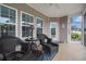 Inviting screened-in porch with comfortable seating and serene views of the outdoors at 325 Galway Ct., Longs, SC 29568