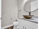 Powder room features a vessel sink and a round mirror above a white vanity at 3995 Tillmond Dr., Conway, SC 29526