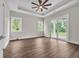 Bedroom with tray ceilings, two windows, and a glass sliding door leading to an outdoor patio at 3995 Tillmond Dr., Conway, SC 29526