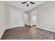 An empty bedroom with a ceiling fan and wood-look flooring, next to a bathroom at 3995 Tillmond Dr., Conway, SC 29526