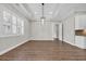 Dining room with a modern chandelier, tray ceiling, and large window for natural light at 3995 Tillmond Dr., Conway, SC 29526