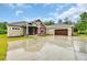 Exterior view of home showcasing red and tan siding, stylish stonework, and an attached two-car garage at 3995 Tillmond Dr., Conway, SC 29526
