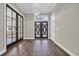 Elegant foyer showcasing hardwood floors, sophisticated lighting and a view of the decorative front doors at 3995 Tillmond Dr., Conway, SC 29526