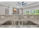 A close-up of a kitchen sink with stainless steel fixtures and a granite countertop at 3995 Tillmond Dr., Conway, SC 29526