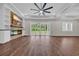 Bright living room with a stone fireplace and sliding glass doors to the backyard at 3995 Tillmond Dr., Conway, SC 29526