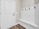 Mudroom featuring a built-in bench with storage and coat hooks, next to the front door at 3995 Tillmond Dr., Conway, SC 29526