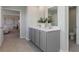 Well-lit bathroom with double vanity, sleek gray cabinets, and a tiled floor at 406 Glade Ct., Loris, SC 29569