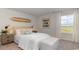 Coastal bedroom with surfboard decor, bench, and bright water view at 406 Glade Ct., Loris, SC 29569
