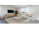 Cozy living room featuring modern furniture, large windows, and hardwood floors at 406 Glade Ct., Loris, SC 29569