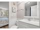 Bathroom with white vanity and framed seahorse wall decor adjacent to the bedroom at 415 Ocean Creek Dr. # 2161, Myrtle Beach, SC 29572