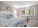 Bright bedroom featuring a decorative mirror, chest of drawers and large window at 415 Ocean Creek Dr. # 2161, Myrtle Beach, SC 29572