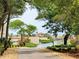 Scenic view of the community with a pond, lush landscaping, and building in the distance at 415 Ocean Creek Dr. # 2161, Myrtle Beach, SC 29572