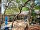 Charming courtyard featuring a fountain, seating, lush greenery, and shade trees, a tranquil outdoor space at 415 Ocean Creek Dr. # 2161, Myrtle Beach, SC 29572