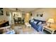 Cozy living room featuring a blue sofa, coastal decor, and an open layout with views of the kitchen at 415 Ocean Creek Dr. # 2161, Myrtle Beach, SC 29572