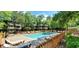 Exterior view of the pool area surrounded by lounge chairs and greenery at 415 Ocean Creek Dr. # 2161, Myrtle Beach, SC 29572
