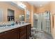 Bathroom featuring double sinks, framed mirrors, wood cabinets, and a walk-in shower at 436 Cotton Grass Dr., Loris, SC 29569