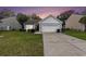 Charming single-story home featuring a two-car garage and a well-maintained lawn at sunset at 436 Cotton Grass Dr., Loris, SC 29569