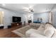 Bright living area with wood floors, sectional sofa, and a large flatscreen TV on fireplace stand at 436 Cotton Grass Dr., Loris, SC 29569