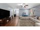 Open living room featuring wood floors, modern sectional, and a large flatscreen TV with decor at 436 Cotton Grass Dr., Loris, SC 29569