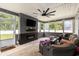 A cozy sun room with plenty of windows, comfortable seating, a ceiling fan, and fireplace at 436 Cotton Grass Dr., Loris, SC 29569