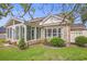 Charming brick home featuring a sunroom extension and a well-maintained lawn with lush landscaping at 44 Hamby Dr., Pawleys Island, SC 29585