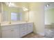 Bright bathroom features a double vanity with a large mirror, providing ample space and natural light at 44 Hamby Dr., Pawleys Island, SC 29585