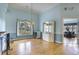 Open dining room with chandelier, large window, hardwood floors and blue walls at 44 Hamby Dr., Pawleys Island, SC 29585