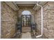 Welcoming brick entrance with a decorative door and sidelights, complemented by lush landscaping at 44 Hamby Dr., Pawleys Island, SC 29585