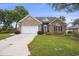 Charming single-story brick home with manicured lawn, two car garage and mature trees at 44 Hamby Dr., Pawleys Island, SC 29585