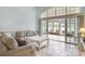 Comfortable living room with plush sofa, tile floors, and sliding glass doors to patio at 44 Hamby Dr., Pawleys Island, SC 29585