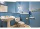 Stylish powder room with blue walls, pedestal sink, and modern fixtures at 44 Hamby Dr., Pawleys Island, SC 29585