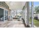 Bright sun room with tile floors, brick accents, and white wicker chairs at 44 Hamby Dr., Pawleys Island, SC 29585