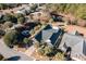 Aerial shot of the house showing lush landscaping, water feature, and surrounding homes at 4608 Grovecrest Circle, North Myrtle Beach, SC 29582