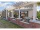 Back porch with pergola covering, equipped with swing bench, and brick half-wall at 4608 Grovecrest Circle, North Myrtle Beach, SC 29582